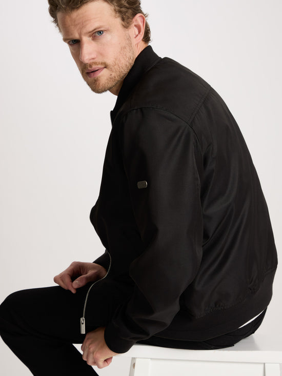 Men's regular bomber jacket with stand-up collar, zip and two pockets, black.