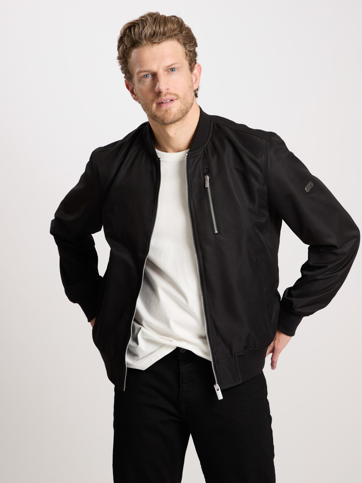 Men's regular bomber jacket with stand-up collar, zip and two pockets, black.