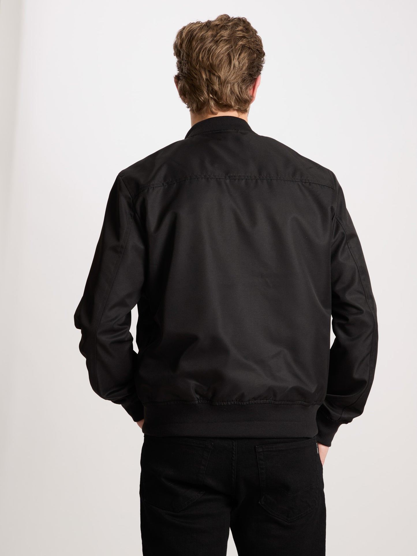 Men's regular bomber jacket with stand-up collar, zip and two pockets, black.