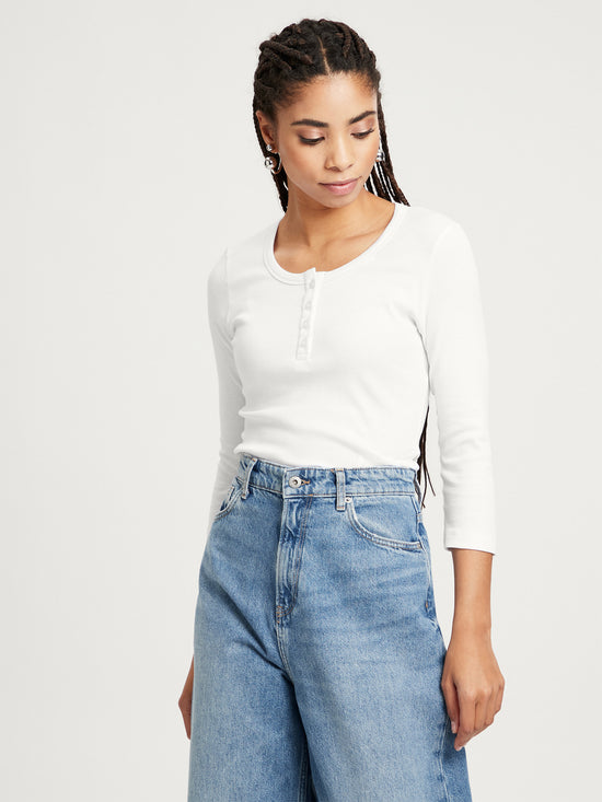 Women's slim long sleeve Henley style ecru.